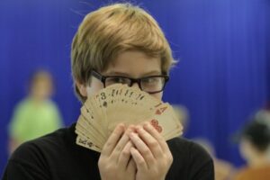 child holding cards for trick